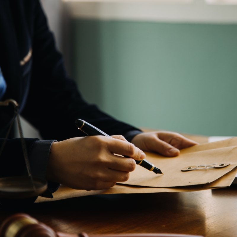 business-lawyers-discussing-contract-papers-with-brass-scale-desk-office-law-legal-services-advice-justice-law-concept-picture-with-film-grain-effect